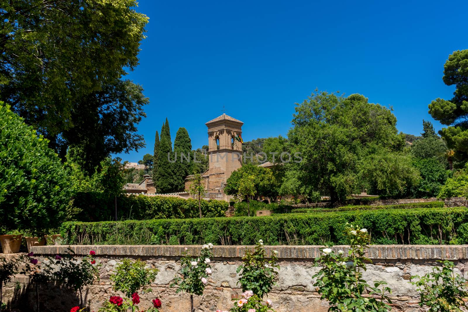 Church in the gardens of Alhambra in Granada, Spain, Europe on a bright sunny day with clear blue sky