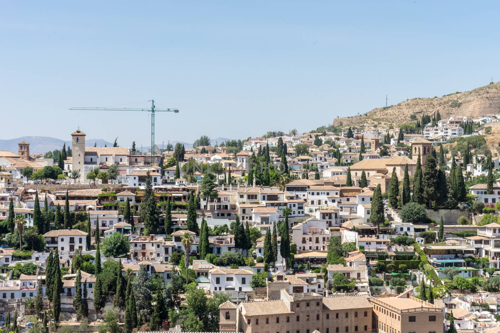 Aerial view of the city of Granada, Albaycin , viewed from the Alhambra palace in Granada, Spain, Europe on a bright summer day with blue sky