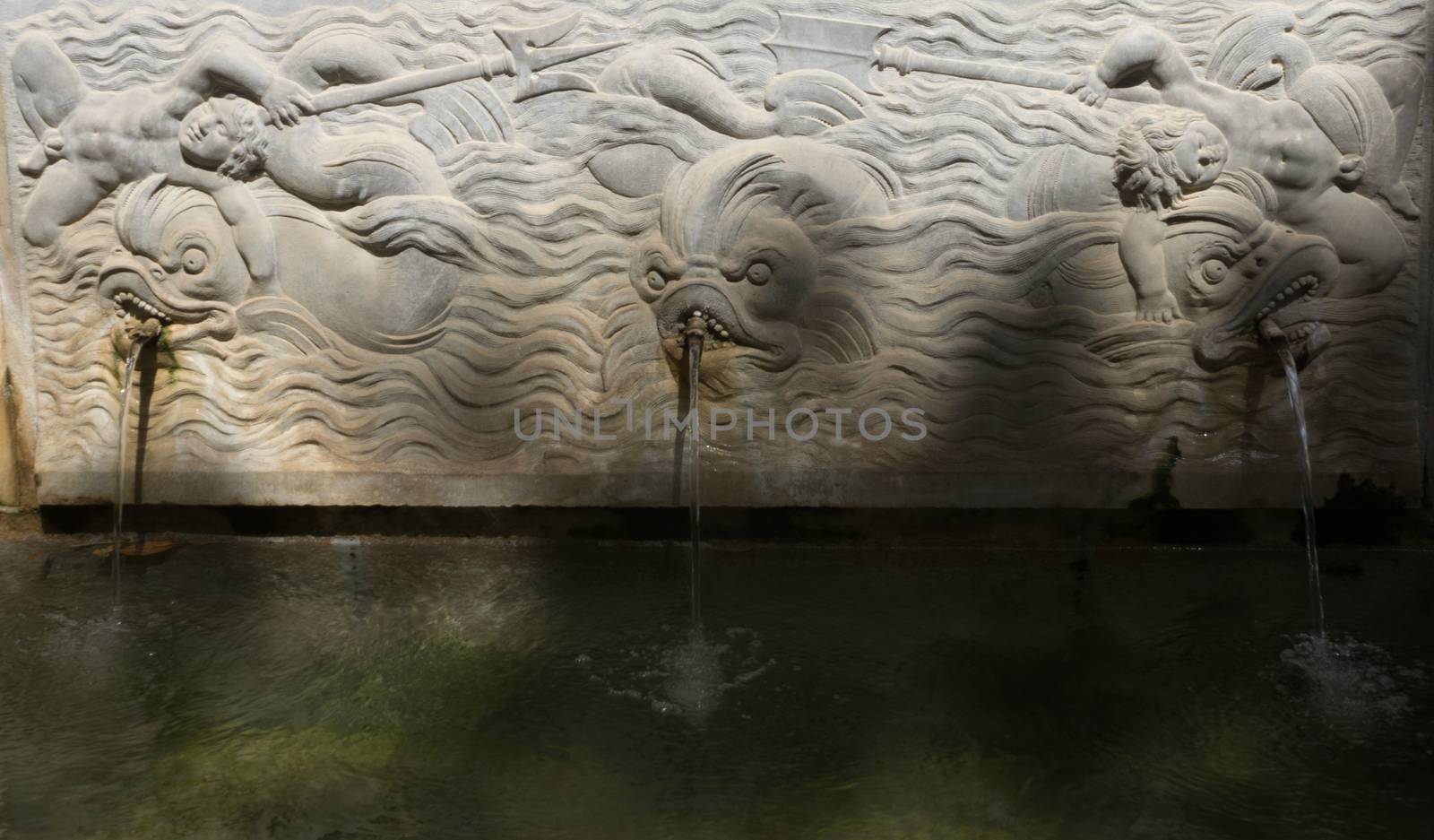 Cool Water fountain with fish in the Alhambra in Granada, Spain, Europe on a bright sunny day