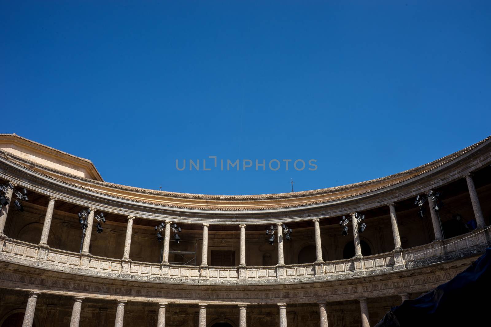 The Colosseum, columns and atrium of Alhambra palace, Granada, Spain, Europe on a bright sunny summer day with clear blue sky