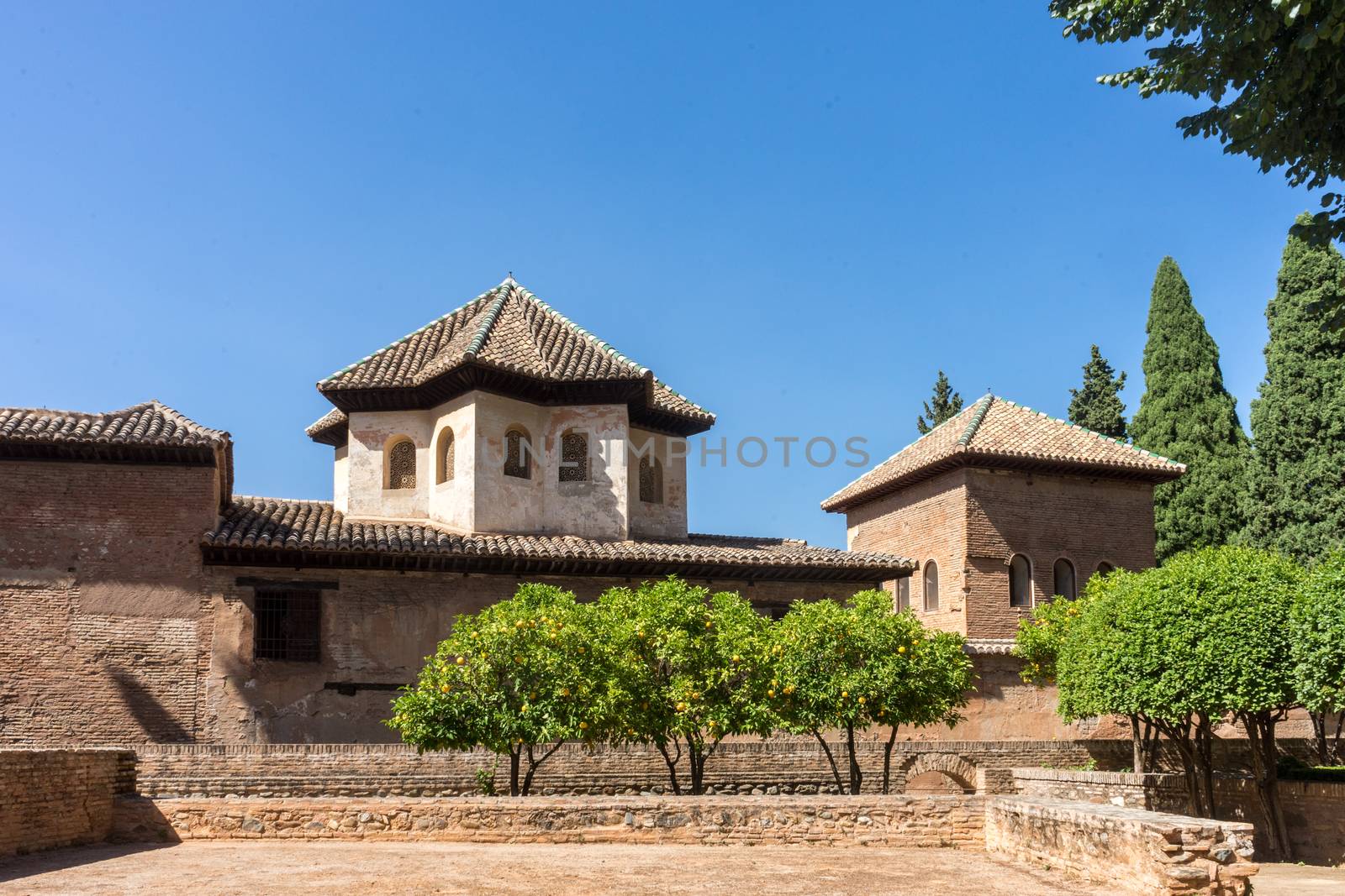 Ruins of former ancient fortress Alhambra. Granada, Andalusia, Spain, Europe on a bright sunny day with clear blue skiy