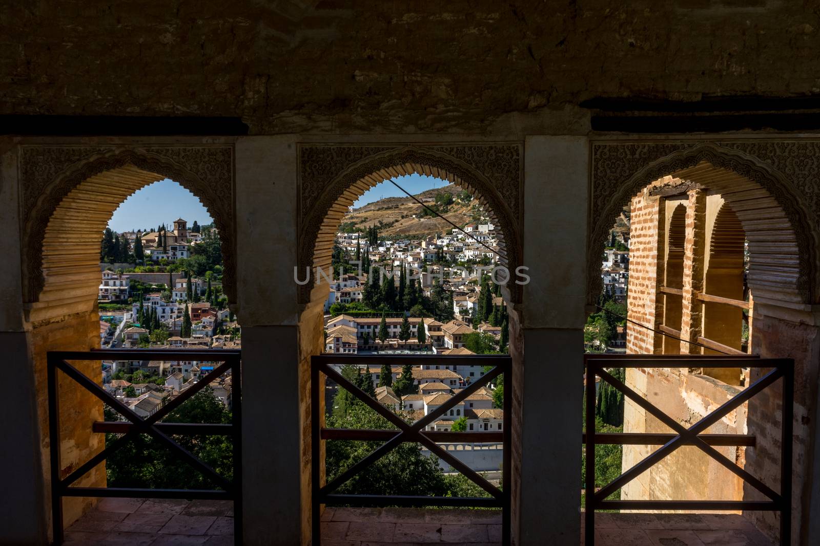 View of the Albayzin district of Granada, Spain, from a window in the Alhambra palace near sunset at Granada, Spain, Europe on a bright sunny day