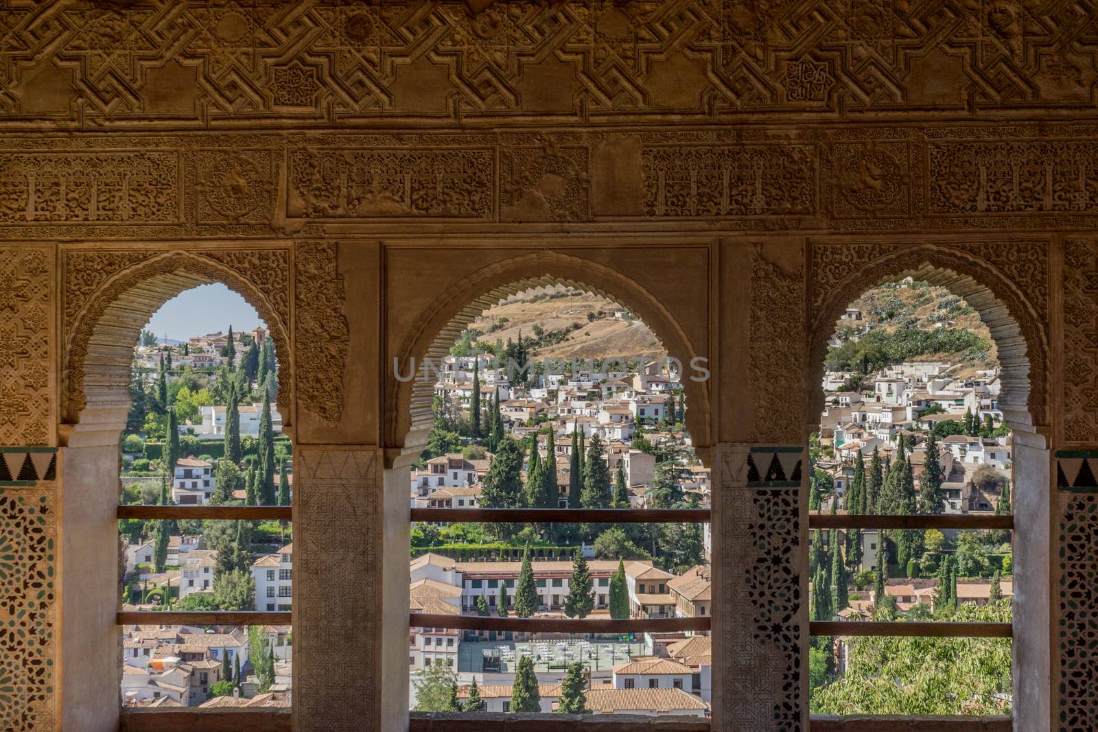 View of the Albayzin district of Granada, Spain, from a window in the Alhambra palace near sunset at Granada, Spain, Europe on a bright sunny day