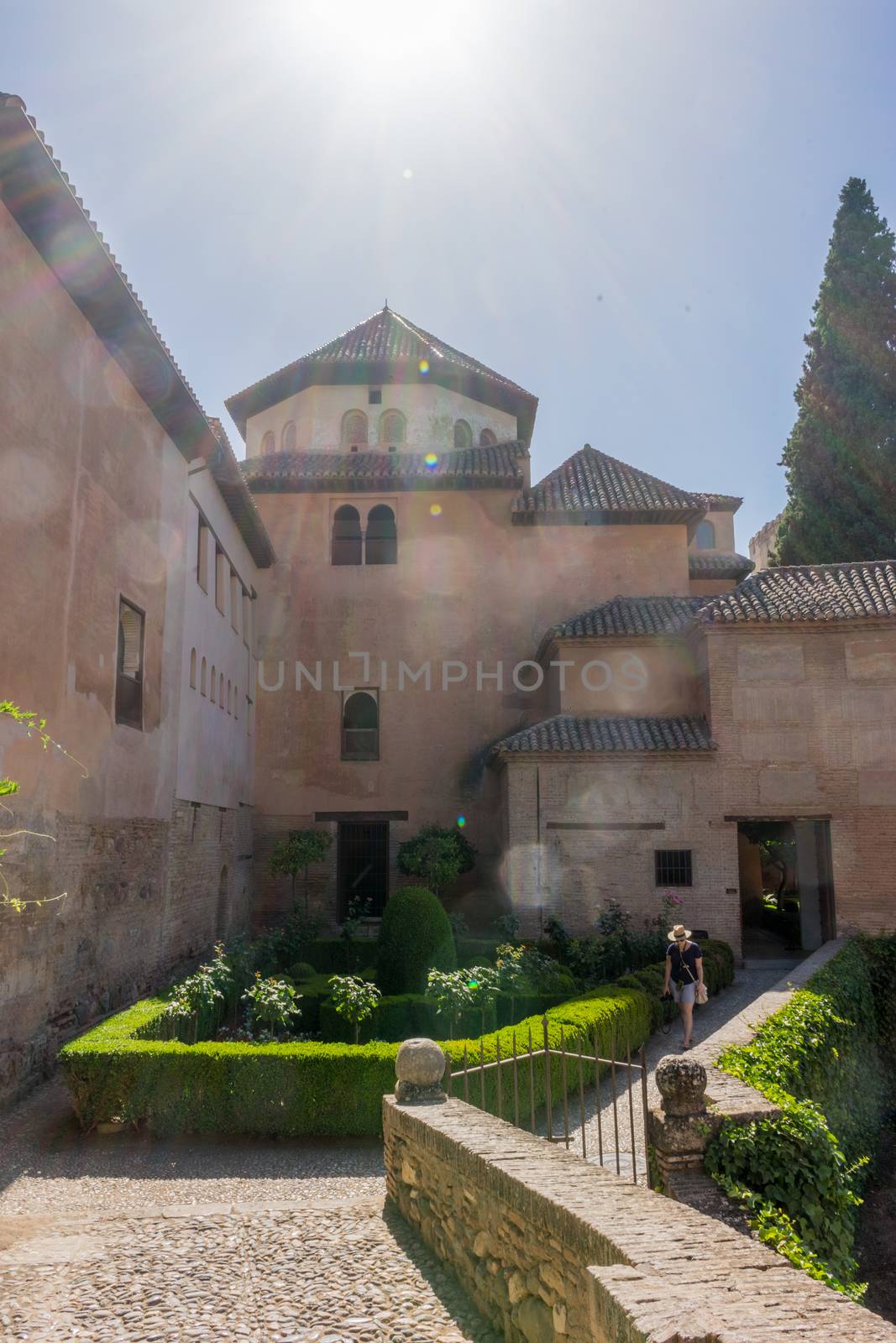 The palace of the Nasrid at Alhambra, Granada, Spain on a brighr summer day with sun flare