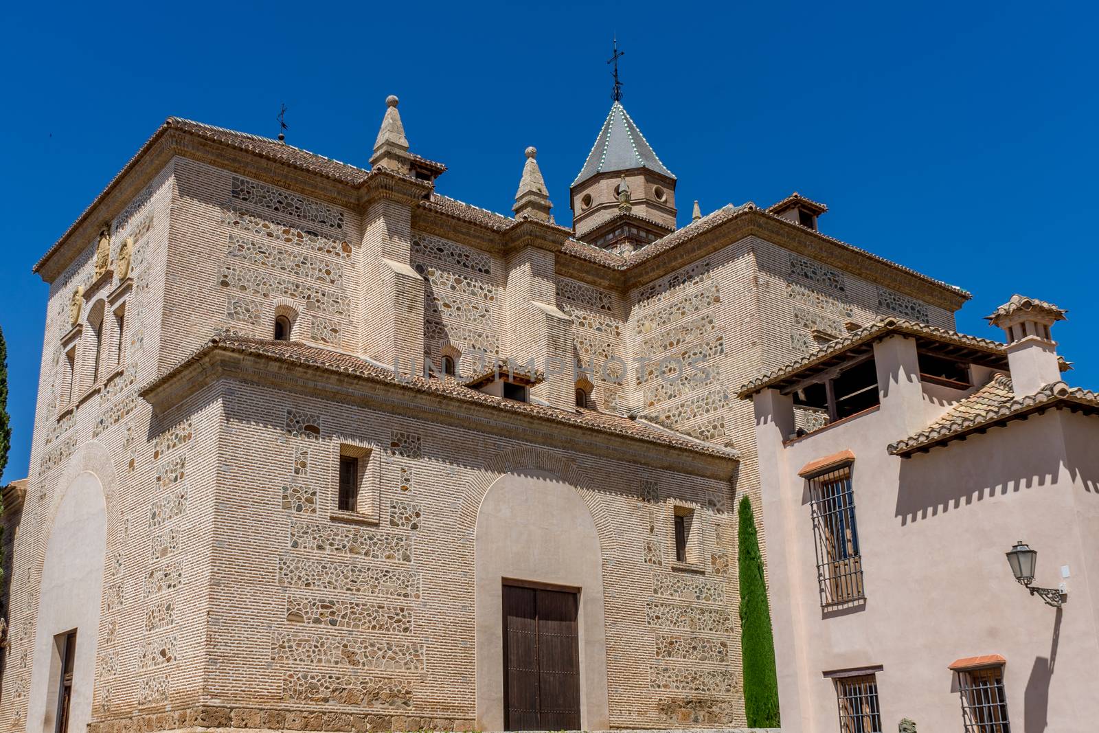 St. Mary Church of the Alhambra (Church of Santa Maria de la Alhambra) at the Alhambra Palace complex in Granada, Andalusia, Spain on a bright sunny day with blue sky