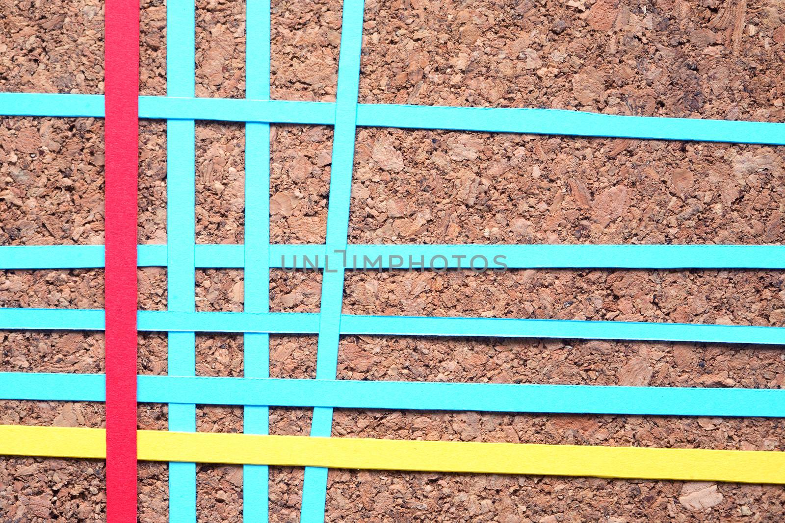 Lot of color paper lines in a row on wooden background