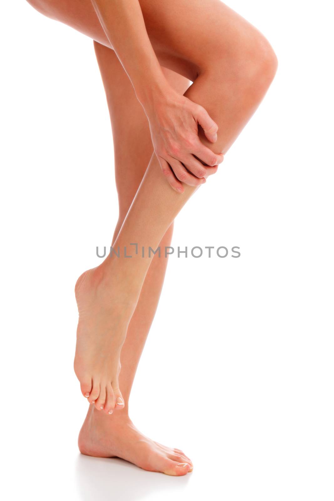 Closeup shot of woman holding sore leg, isolated on white backgr by Nobilior