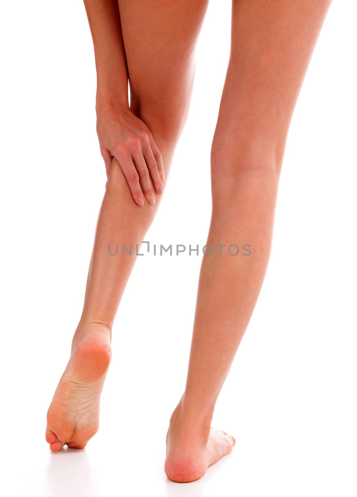 Closeup shot of woman holding sore leg, isolated on white backgr by Nobilior