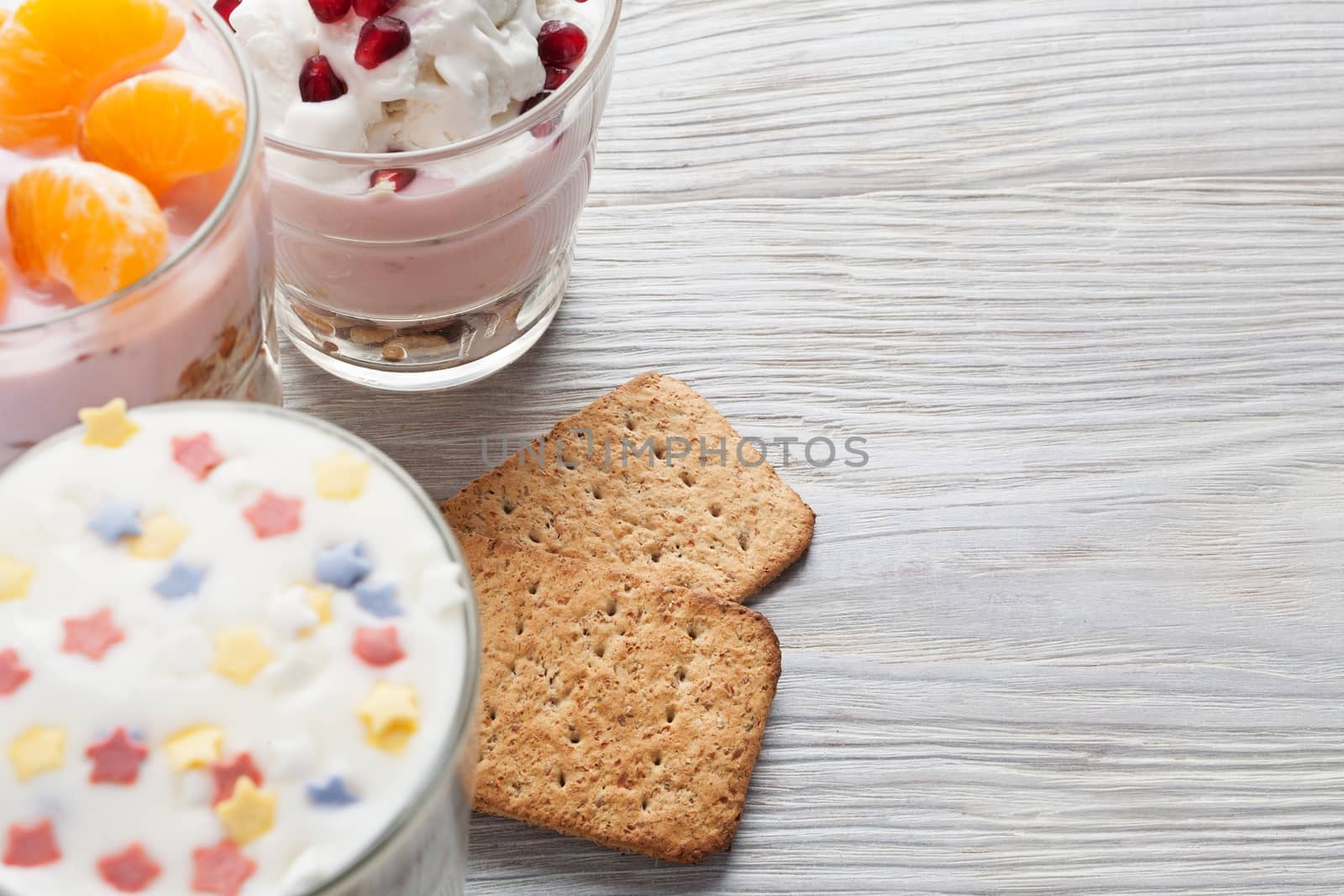 Natural homemade yogurt with fruits on a white wooden background, selective focus, copy space