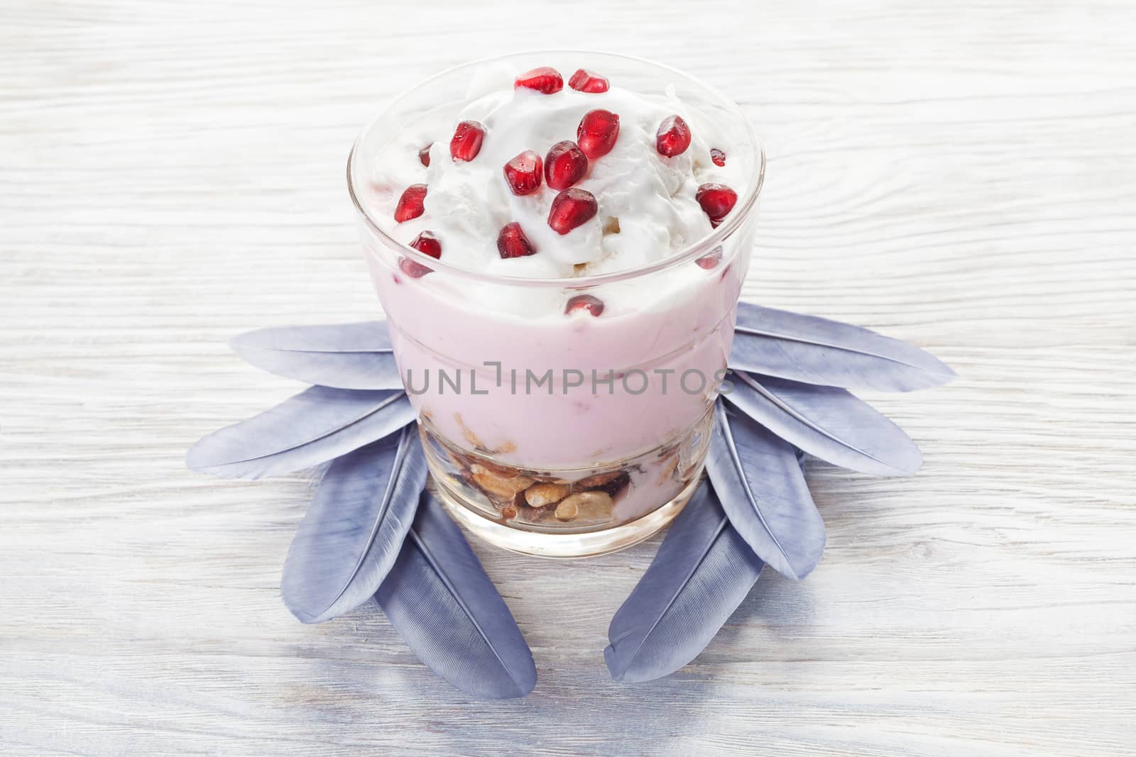 Natural homemade yogurt with fruits on a white wooden background, selective focus