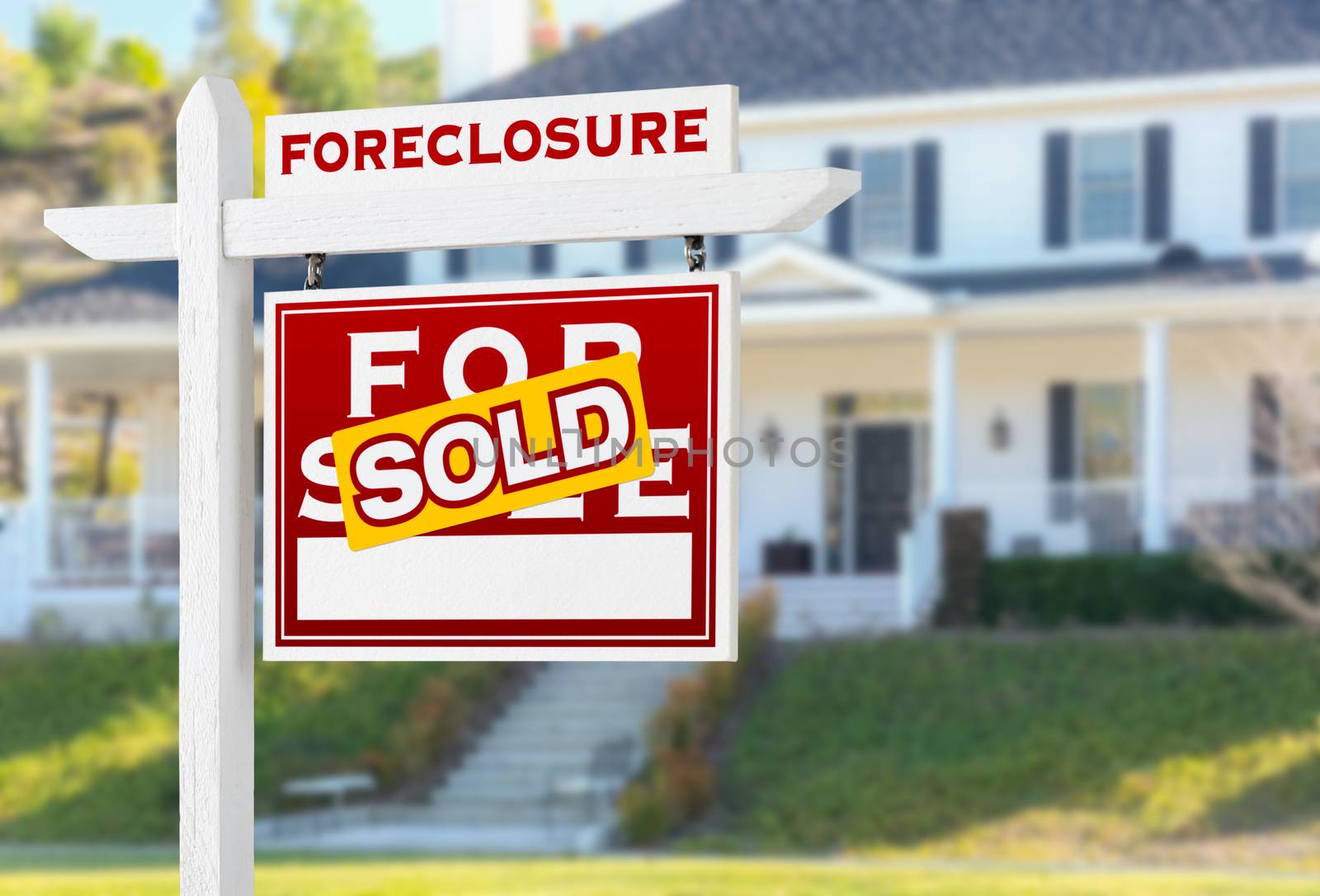 Right Facing Foreclosure Sold For Sale Real Estate Sign in Front of House.