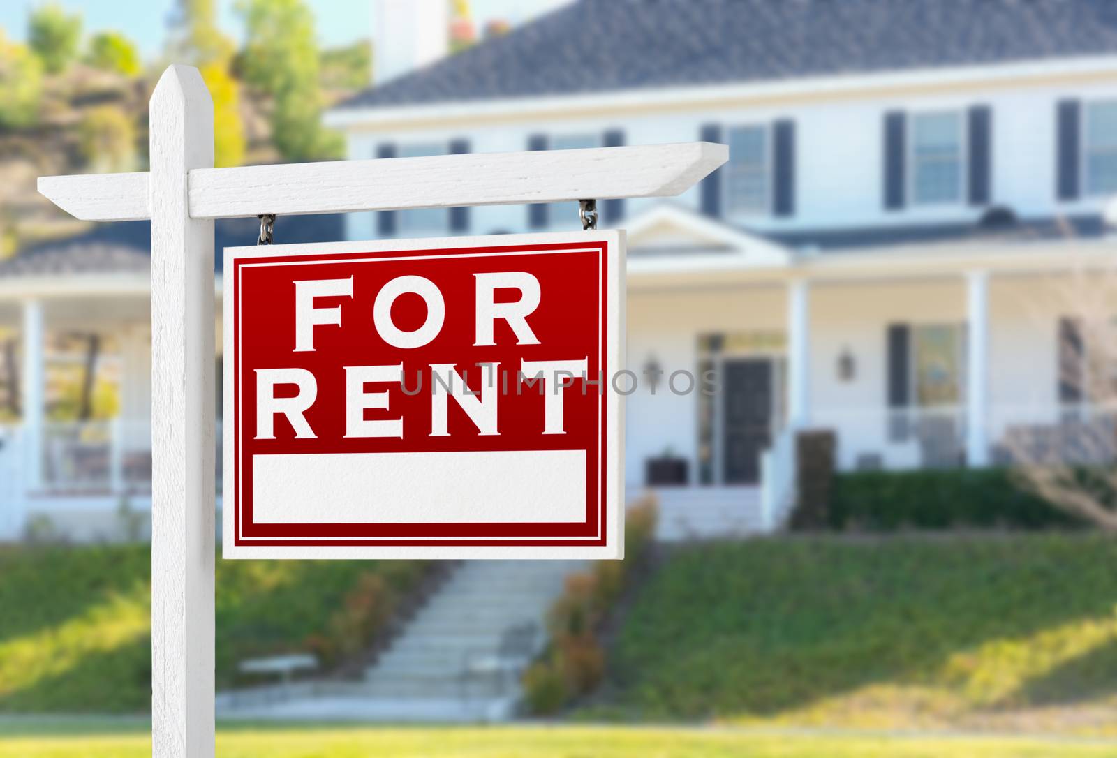 Right Facing For Rent Real Estate Sign In Front of House.