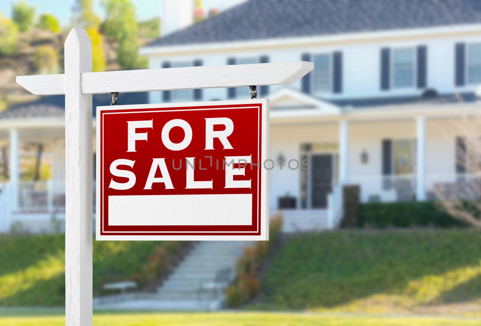 Right Facing For Sale Real Estate Sign In Front of House.