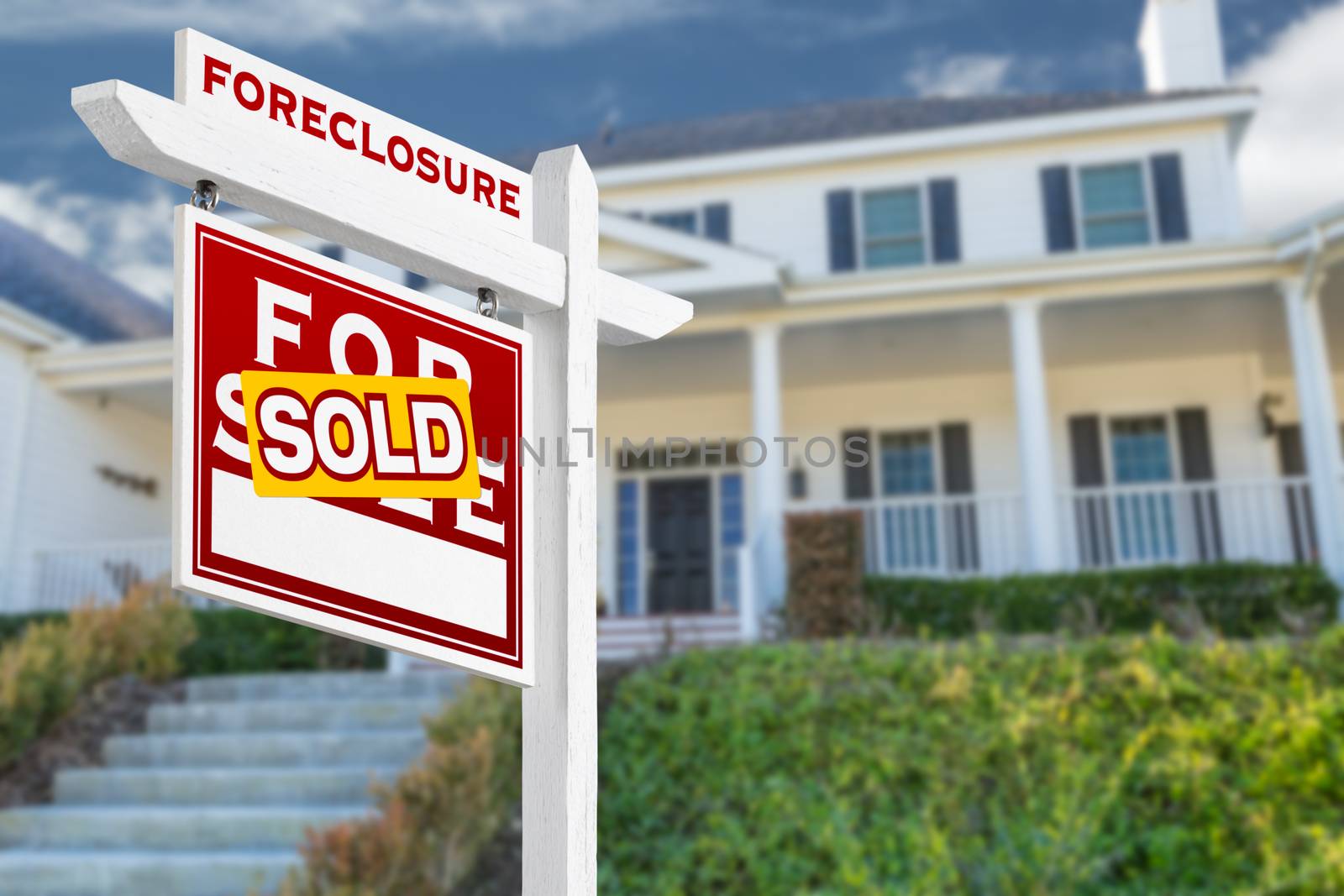 Left Facing Foreclosure Sold For Sale Real Estate Sign in Front of House.