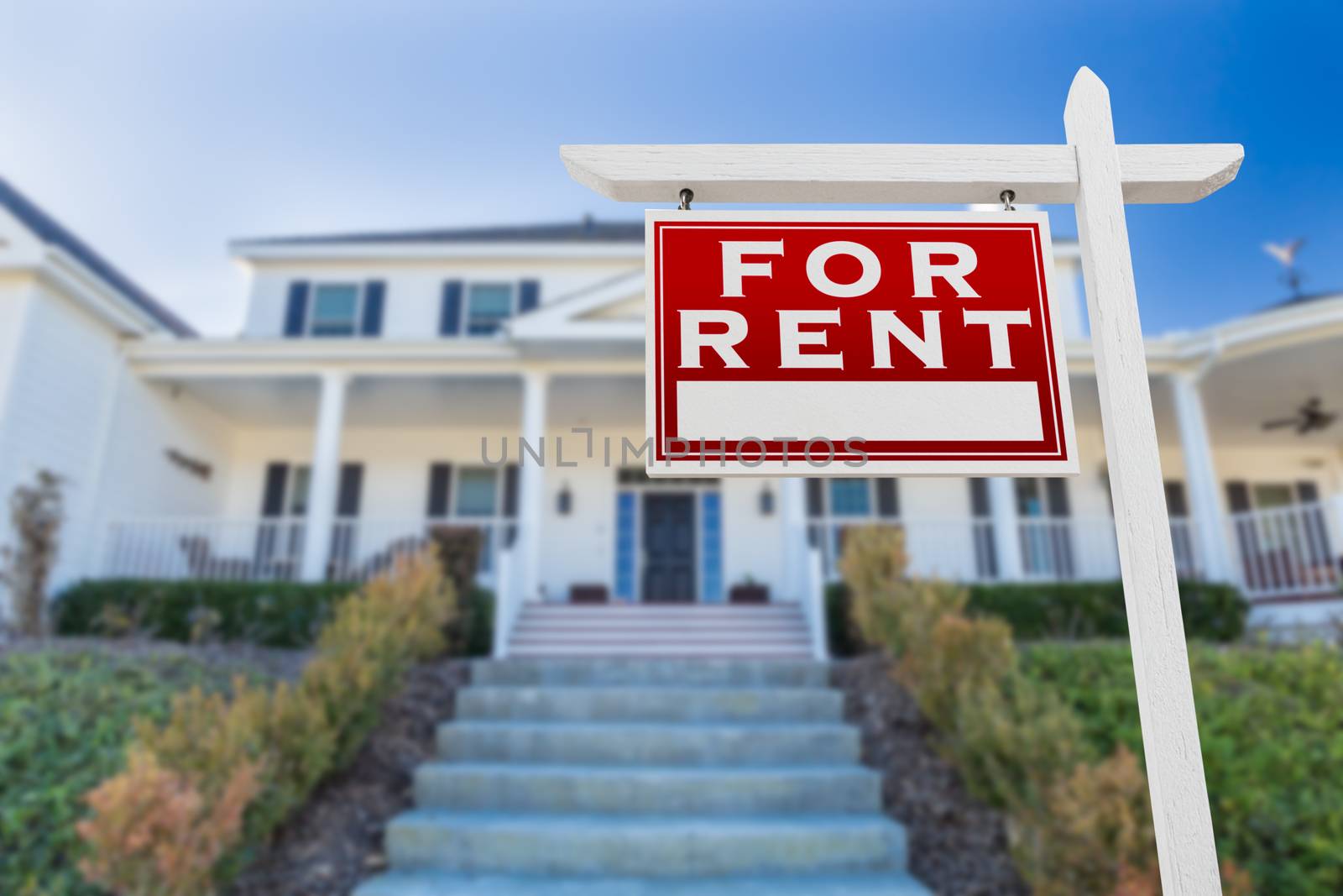 Left Facing For Rent Real Estate Sign In Front of House.