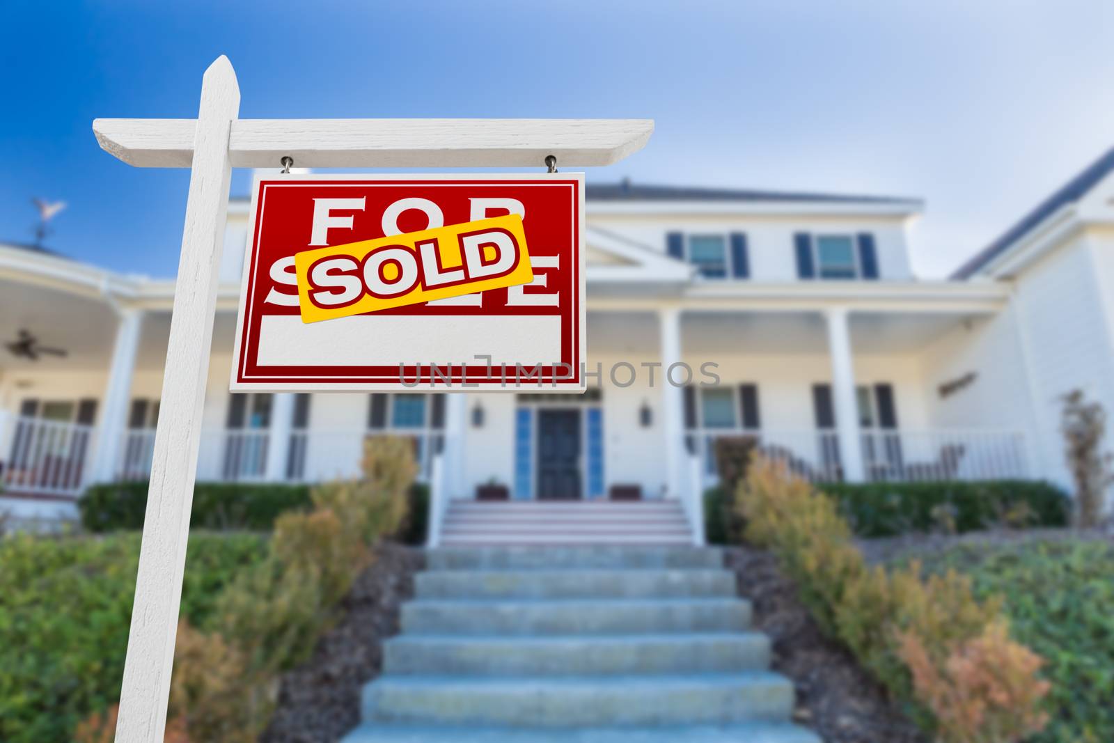 Right Facing Sold For Sale Real Estate Sign In Front of House.