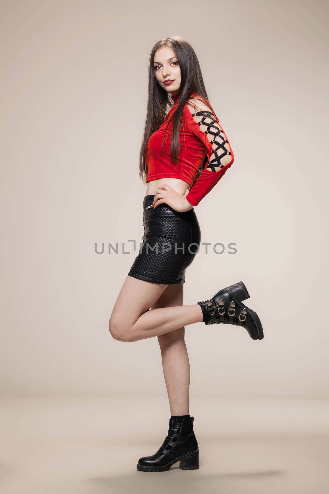 gothic style girl in red shirt, short black dress and boots