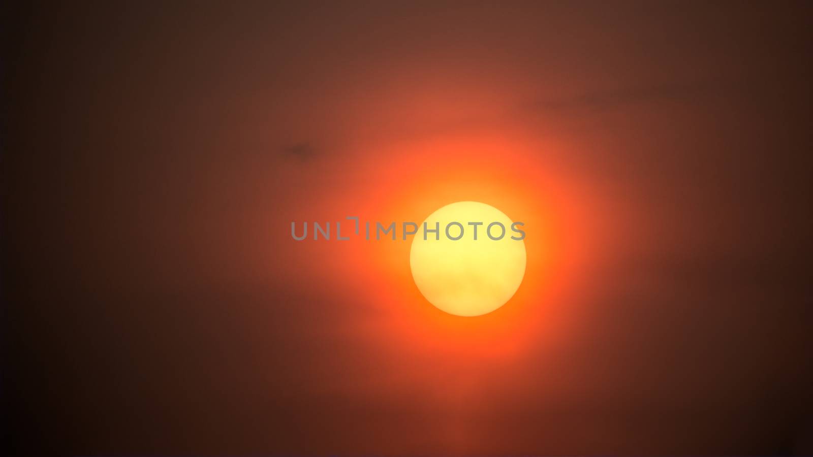 Closeup big yellow sunset on red sky background