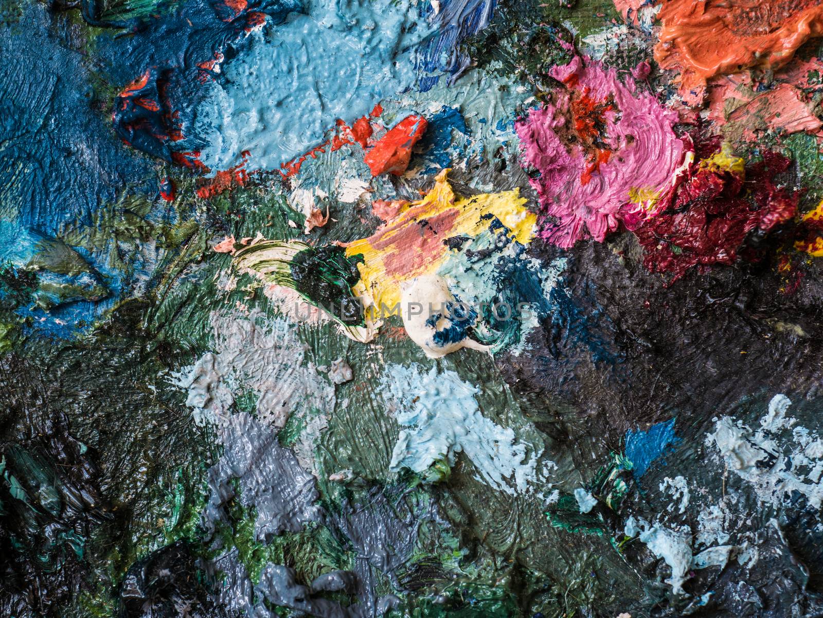 Closeup colorful of oil color on palette of artist