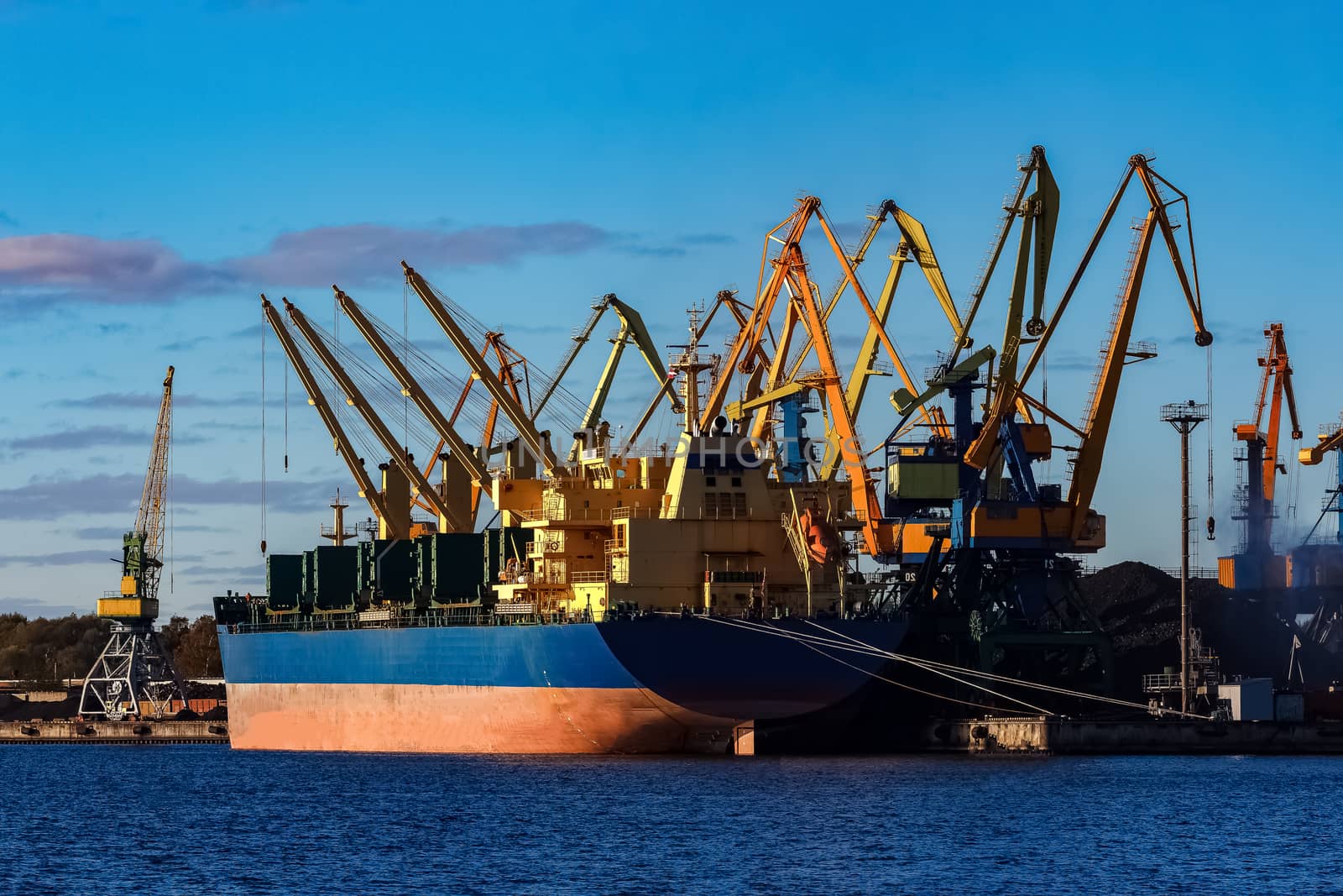 Blue cargo ship loading in the port of Riga, Europe