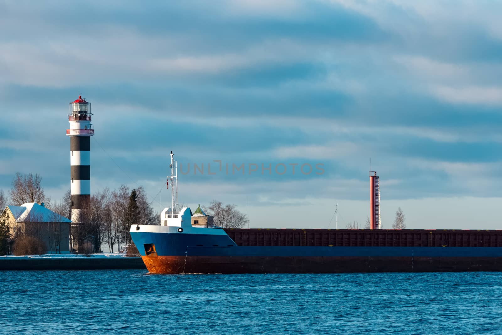 Blue bulk carrier sailing in still water