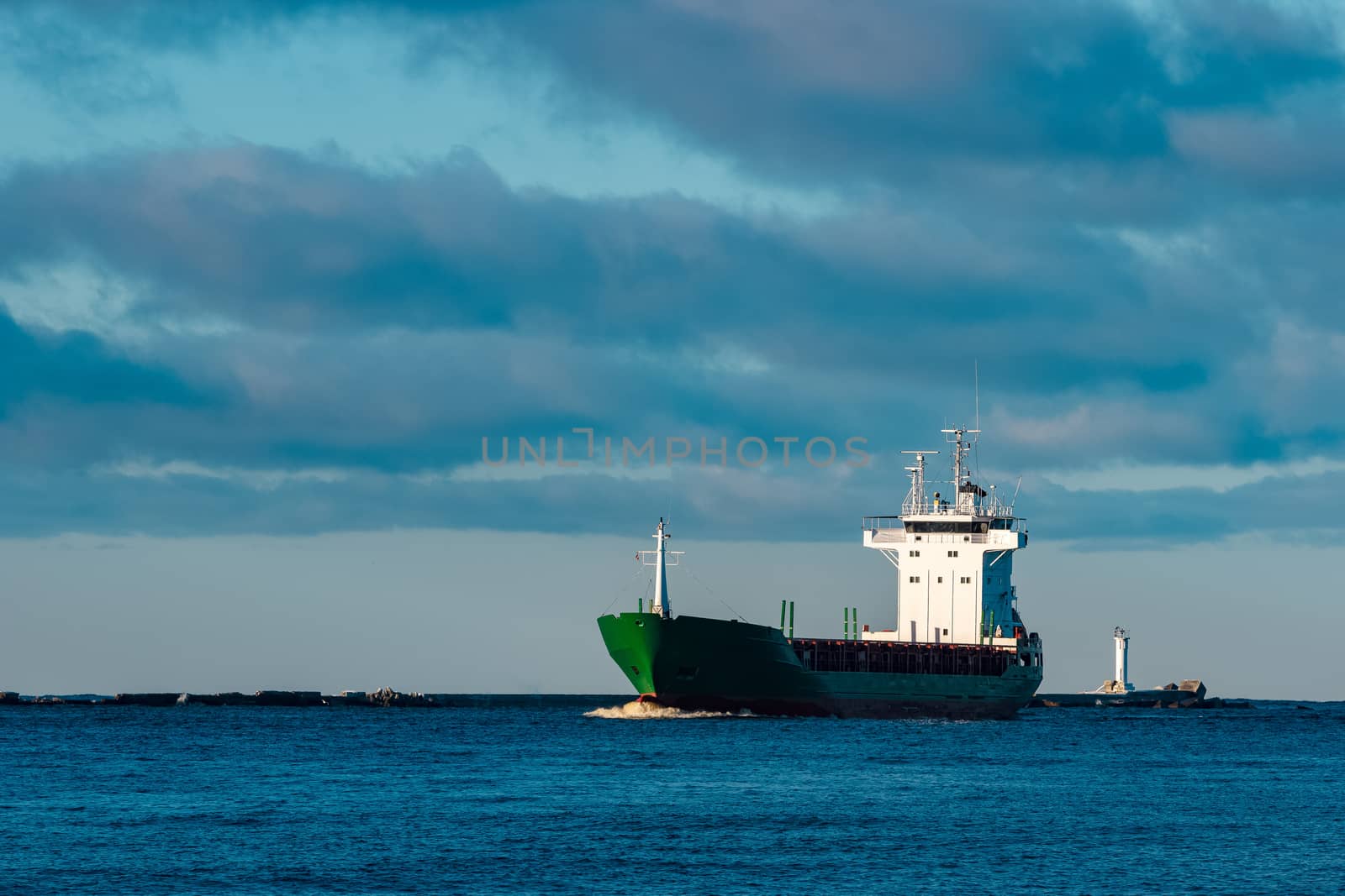 Green bulk carrier sailing from the Baltic sea