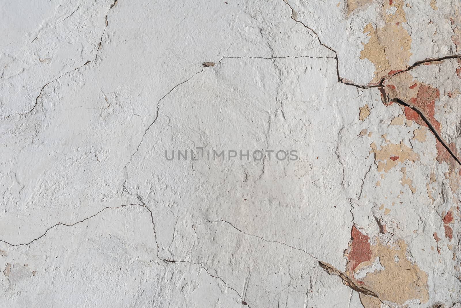 old chipped plaster on the concrete wall, cracks in old concrete wall, background texture by uvisni