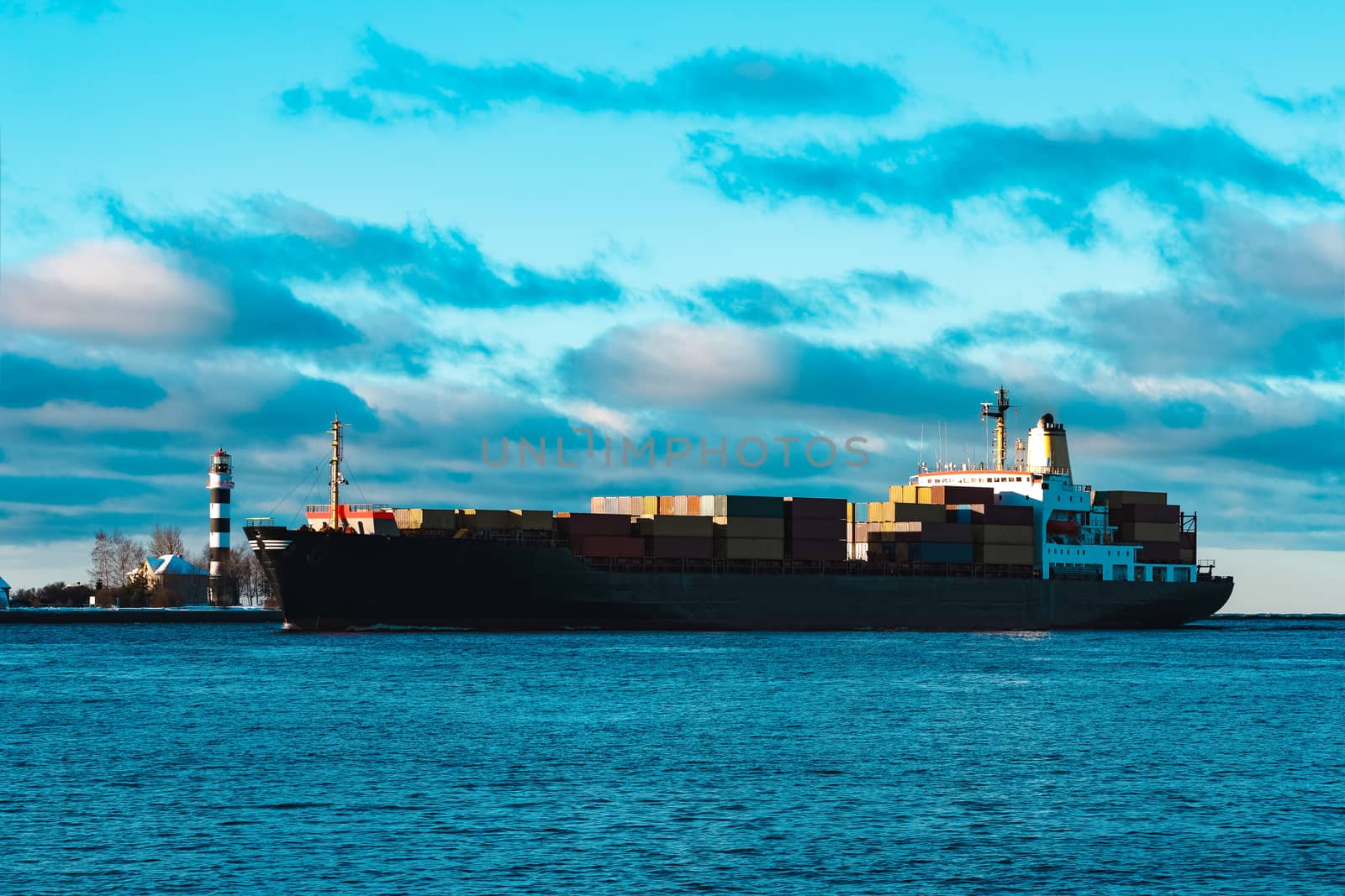 Modern black container ship moving from Baltic sea