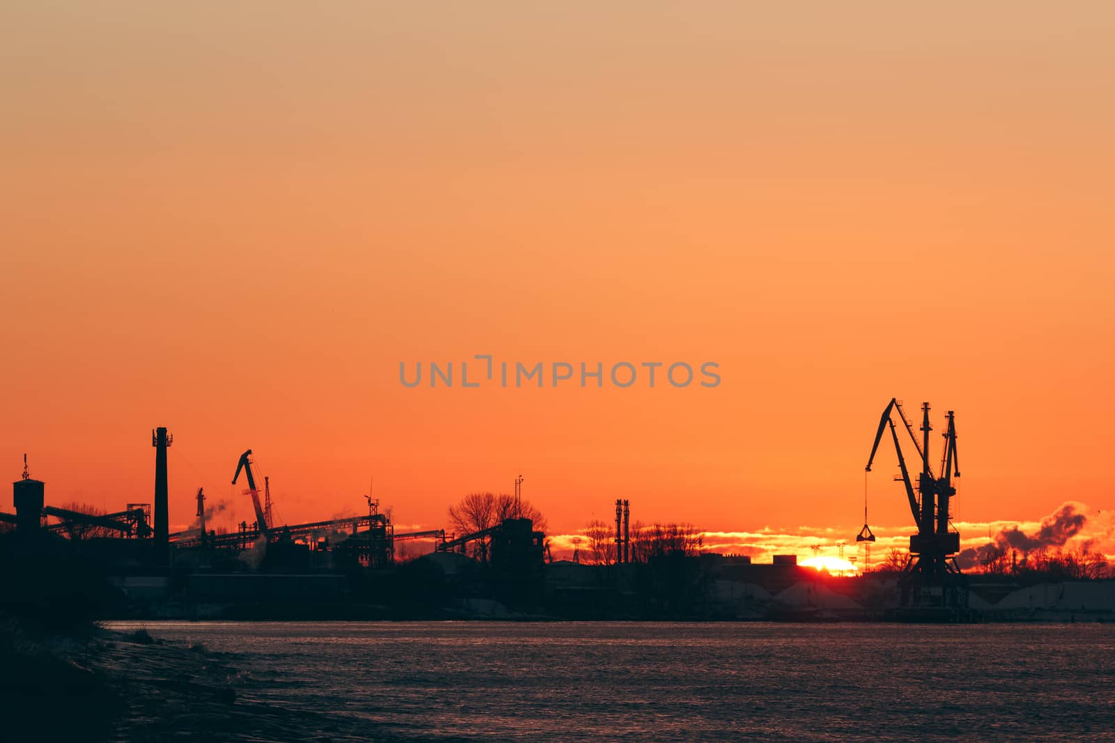 Hot winter sunrise over the cargo port in Riga