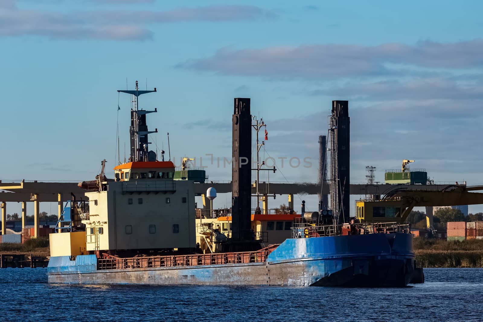 Blue cargo ship in the port of Riga, Europe