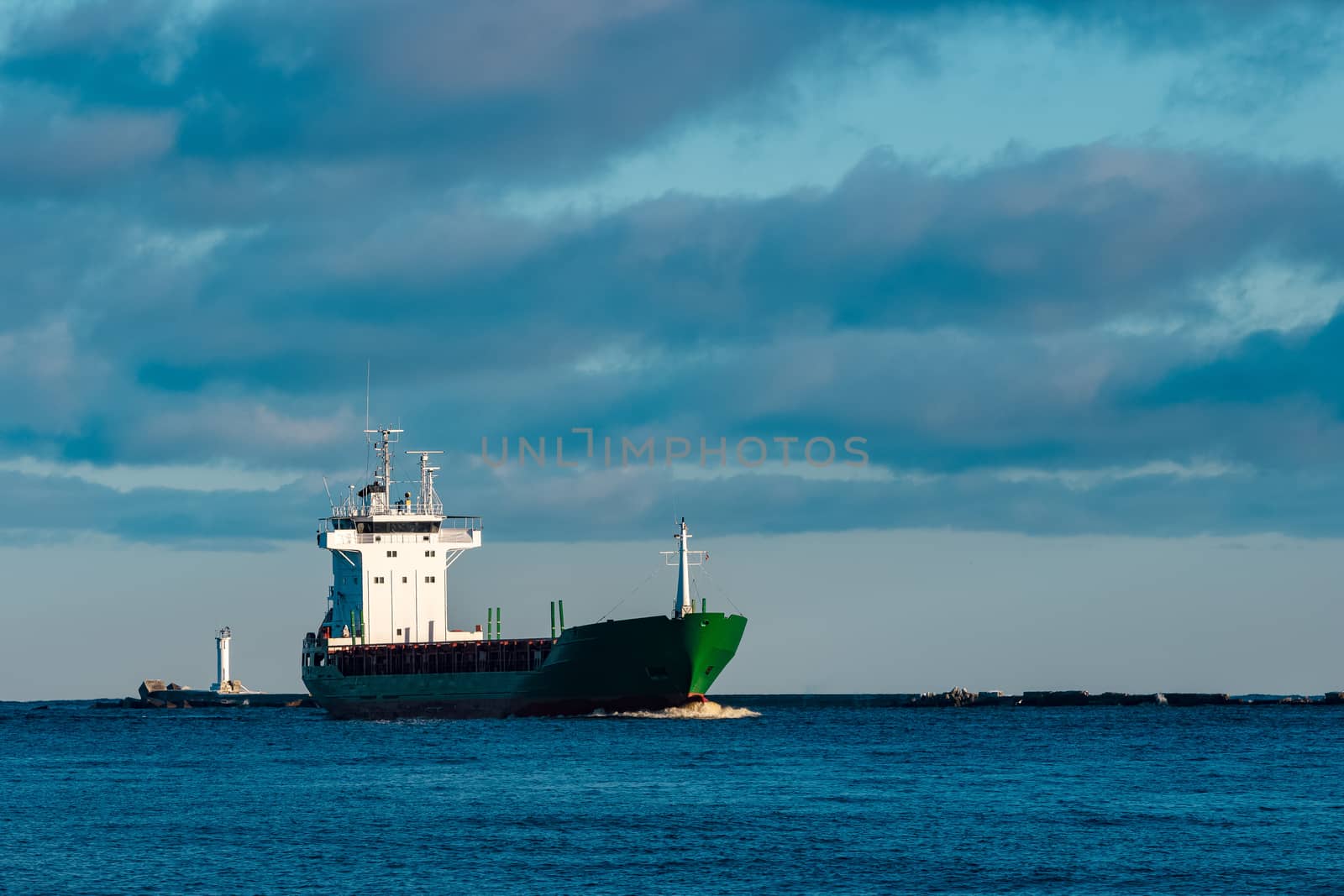 Green bulk carrier sailing from the Baltic sea