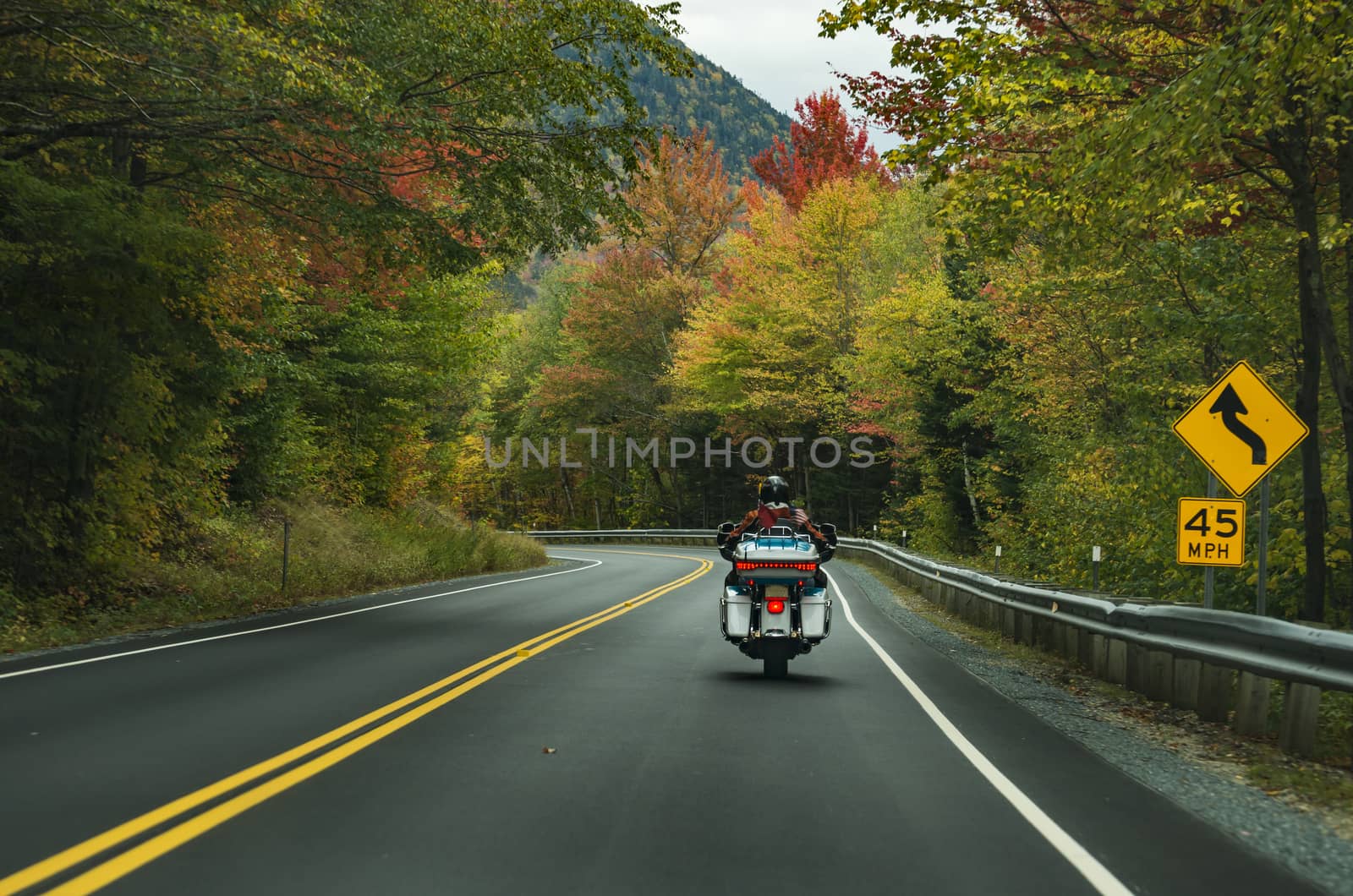 Motorcycle driving on the road on the White Mountains during the fall, New Hampshire, USA