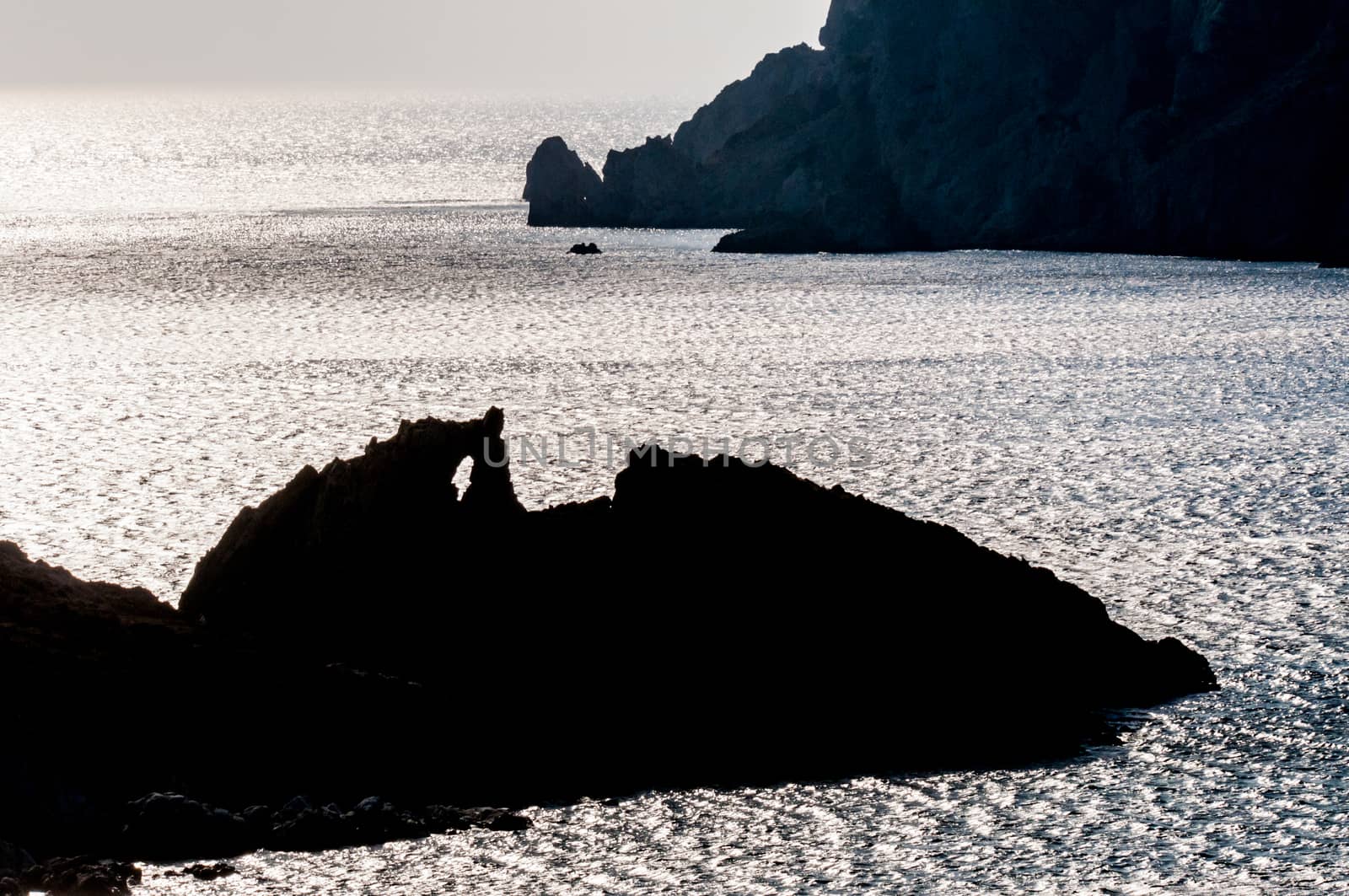 rocky silhouette in sea by vangelis