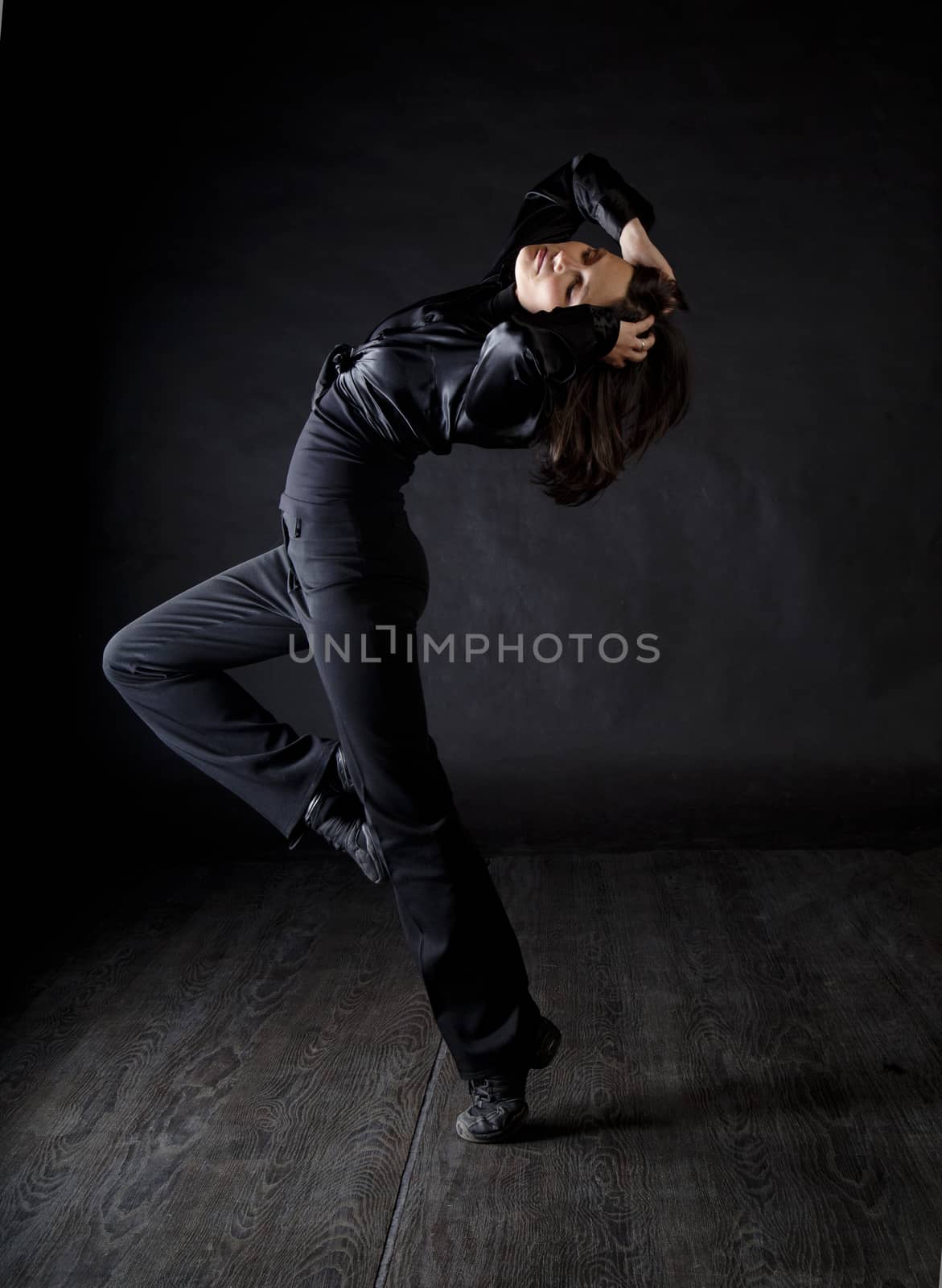 Modern style woman dancer over black background