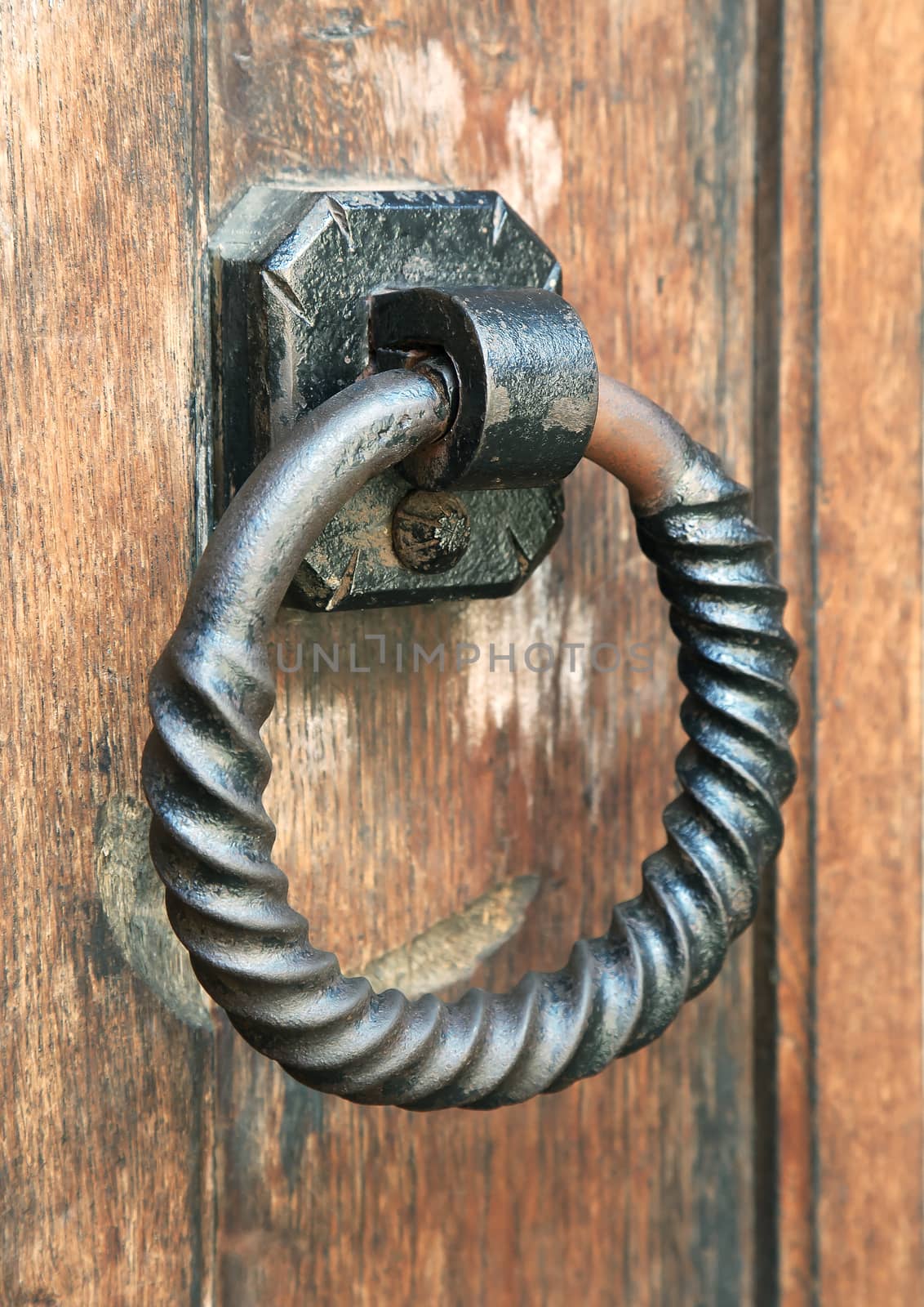 Metal ring door knocker on a medieval wooden door