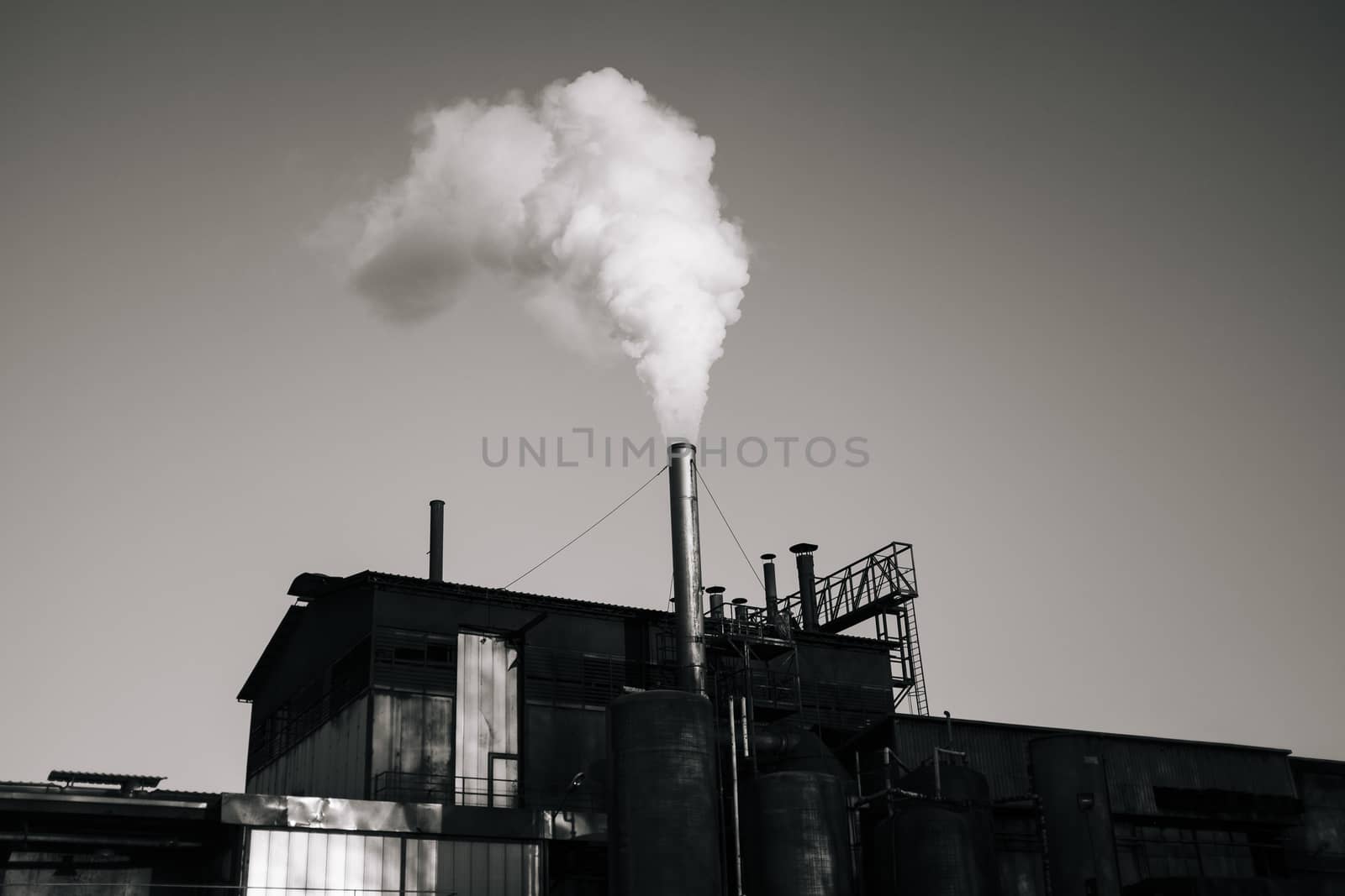 factory emits smoke in the sky by struki
