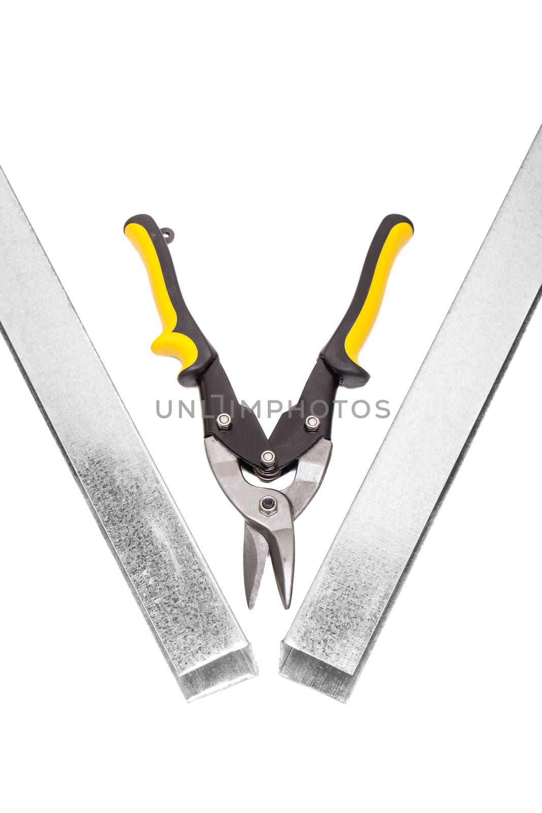 industrial scissors cutting U-shaped metal profile for drywall support isolated on white background