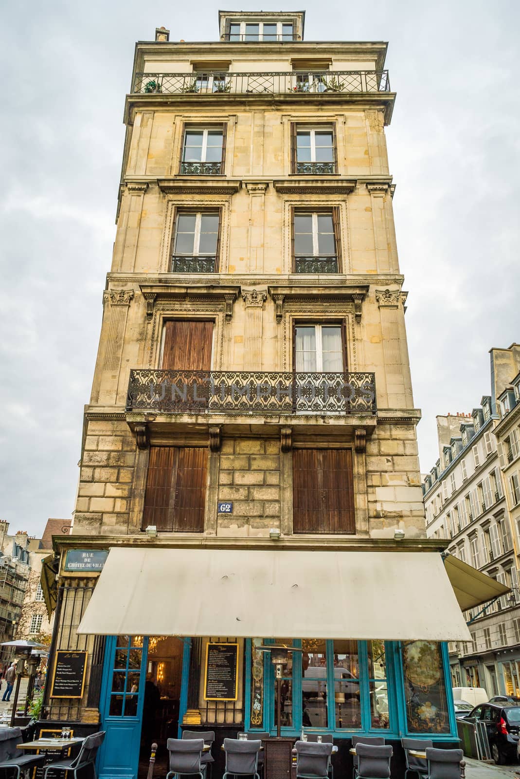 Typical parisian vertical house in Paris with restaurant on the first floor