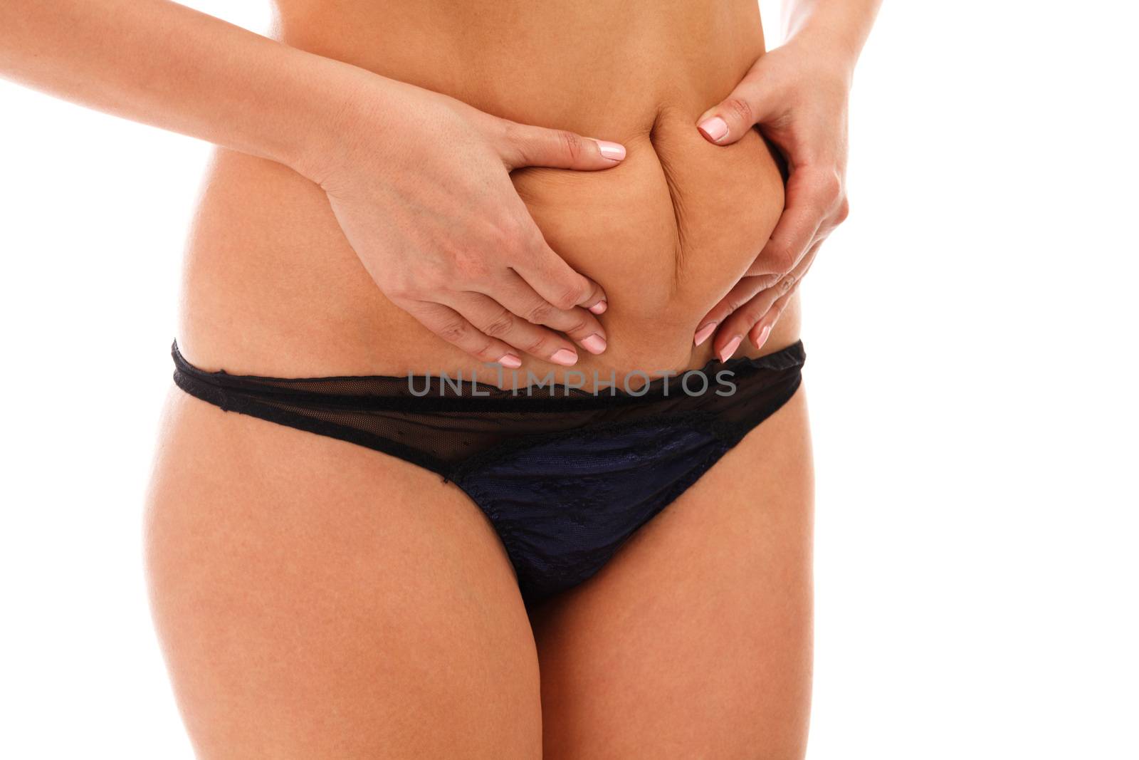 Closeup shot of overweight woman pinching her excessive belly fat, isolated on white background