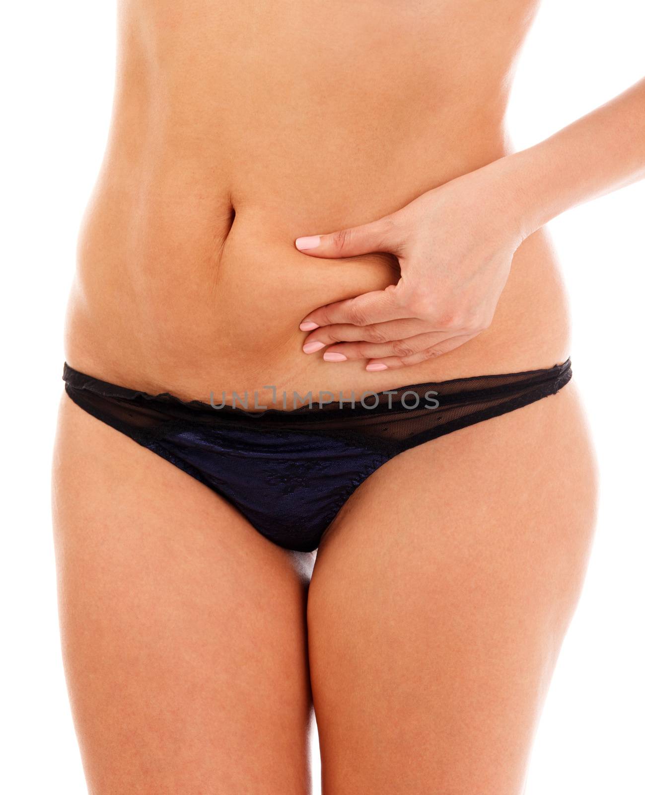 Closeup shot of overweight woman pinching her excessive belly fat, isolated on white background