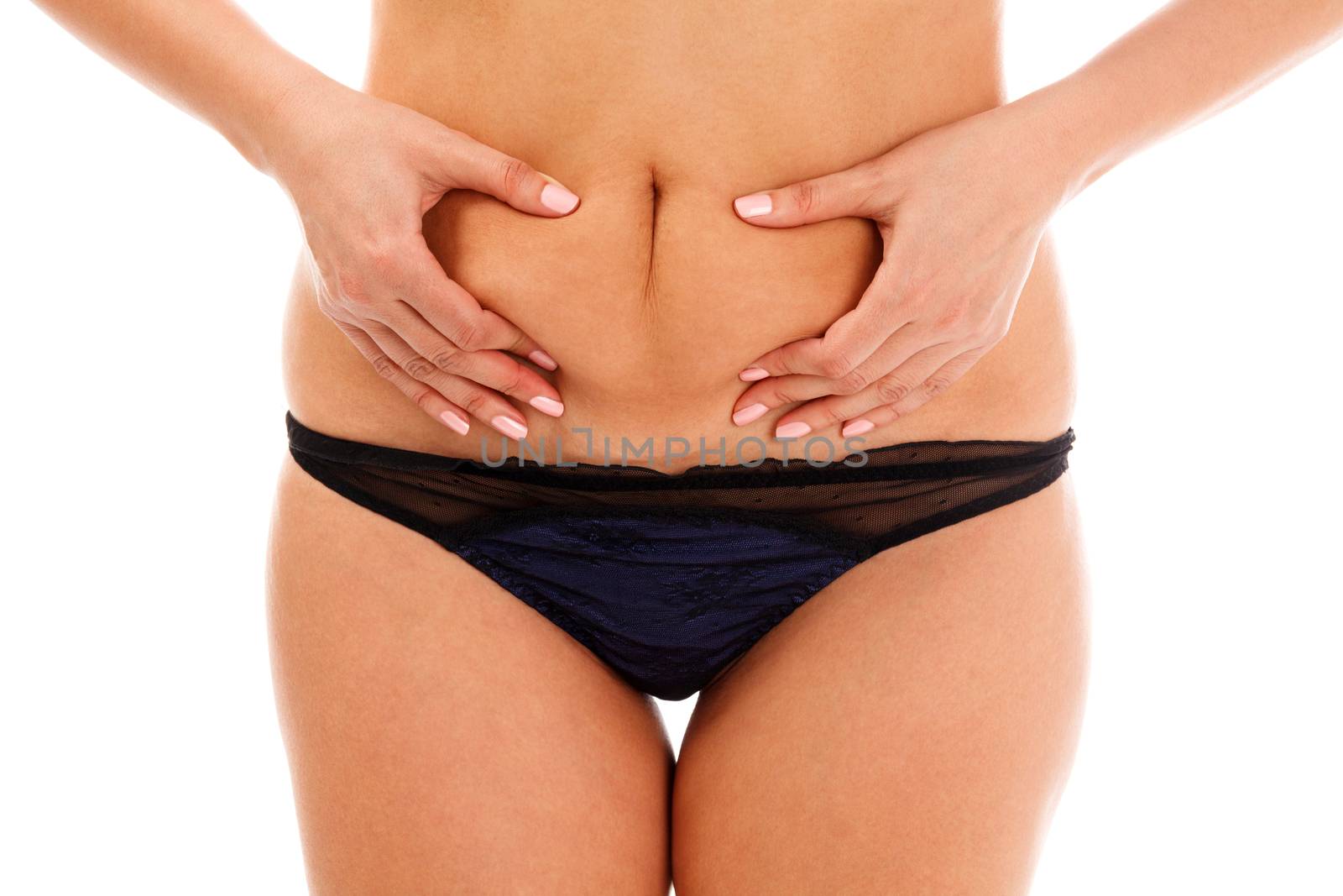 Closeup shot of overweight woman pinching her excessive belly fat, isolated on white background