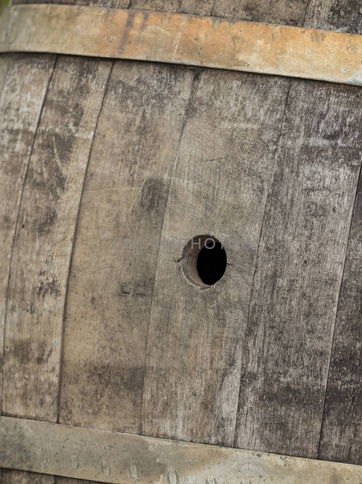 Old wooden barrel with a hole by sandra_fotodesign