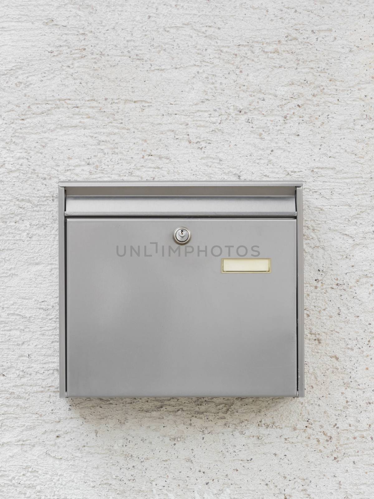 A silver mailbox on the wall by sandra_fotodesign