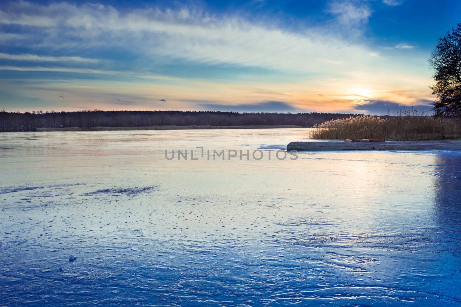 Winter paysage landscape of sunset evening iced frozen lake river