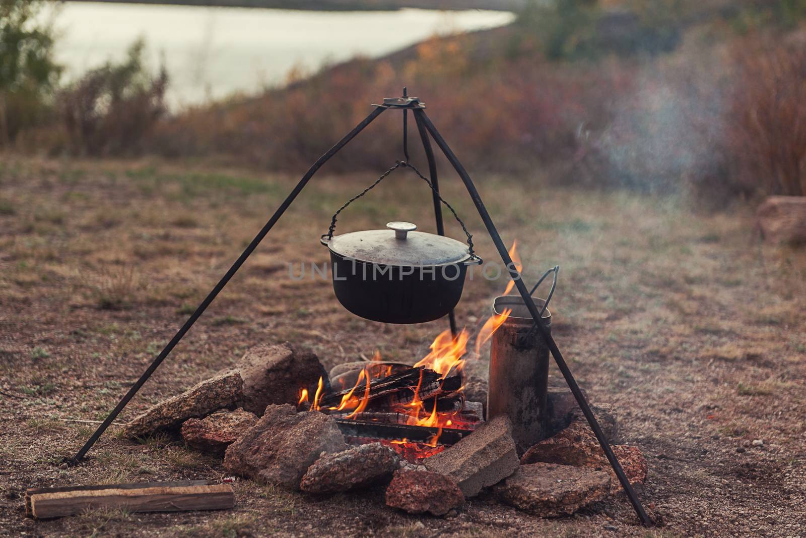 Preparing food on campfire by rusak