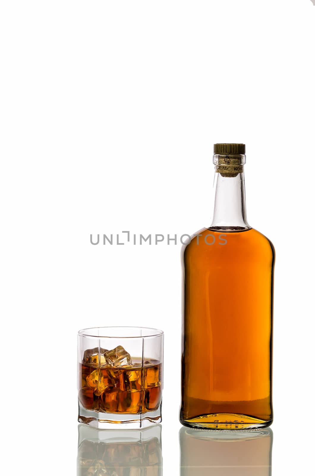 a glass of whiskey with ice isolated on white background