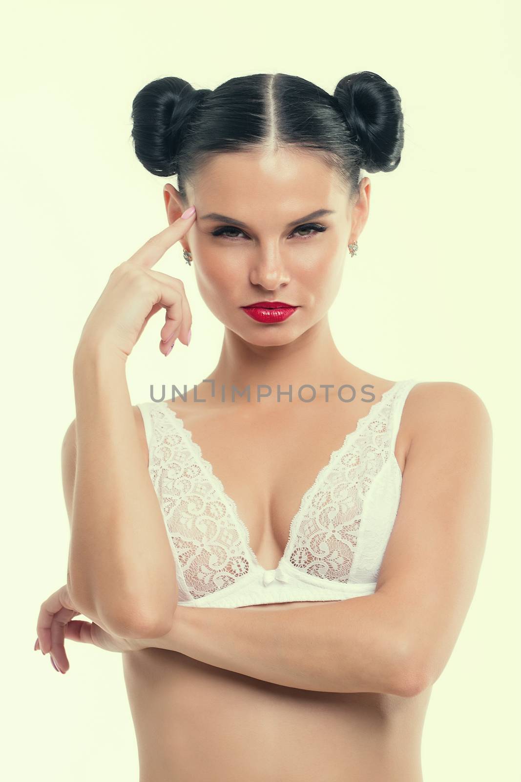 Portrait of a young girl in lingerie with red lipstick.