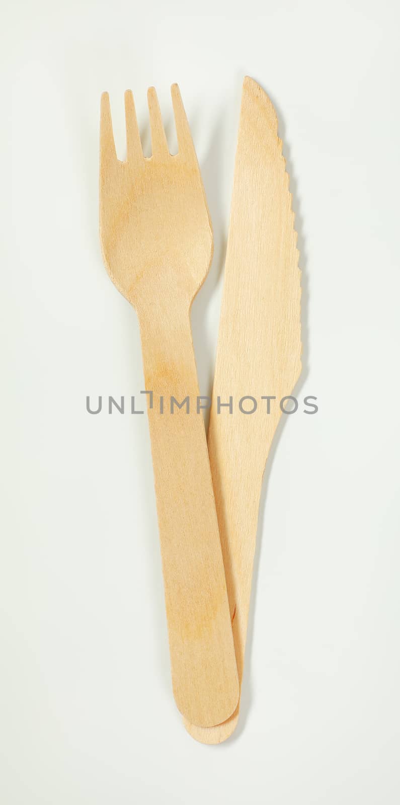 wooden knife and fork on white background