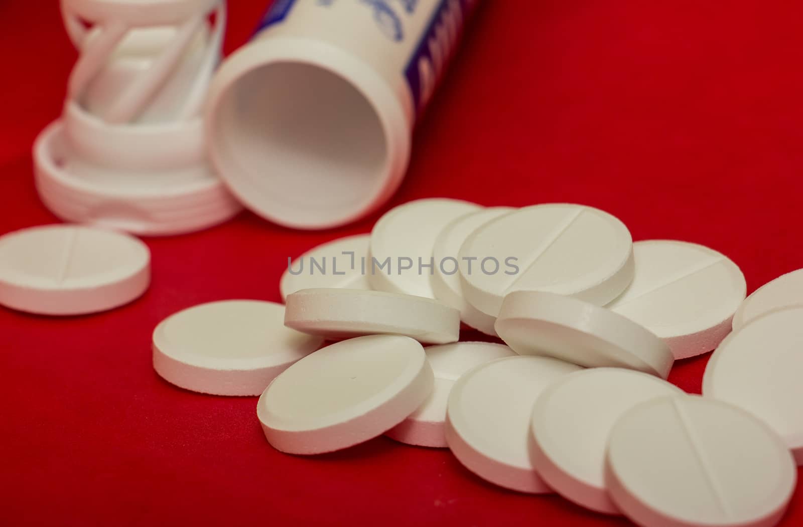 white pills on a red background