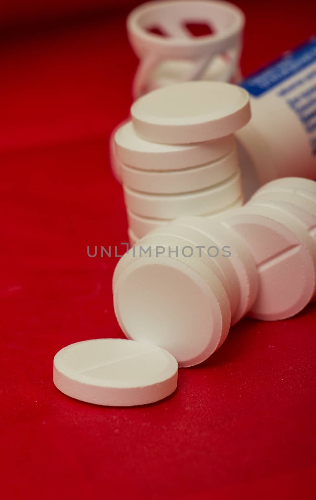 white pills on a red background